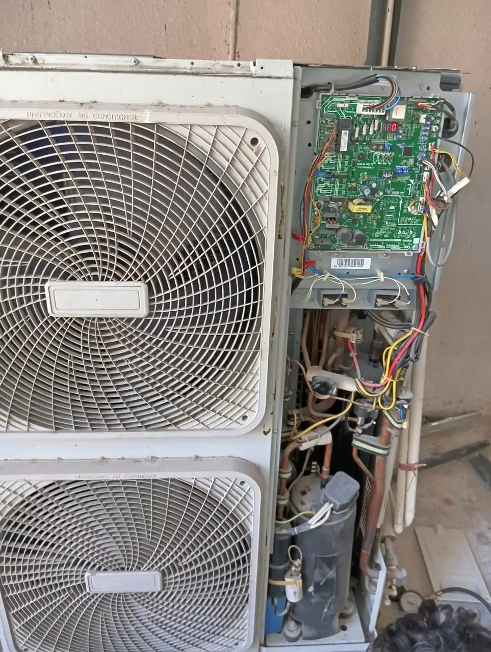 AC service tools and parts organized for repair job